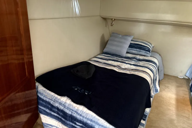 Slide: The Image of Cozy cabin bed in 2004 Wellcraft 47 Excalibur yacht with striped bedding. - 38