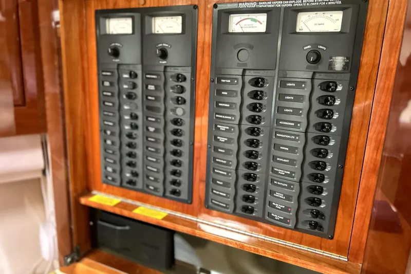 Slide: The Image of Electrical control panel on a 2004 Wellcraft 47 Excalibur boat, featuring switches and gauges. - 39