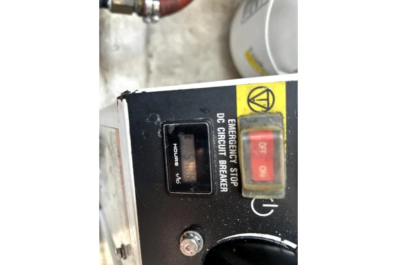 Slide: The Image of Control panel of a 2004 Wellcraft 47 Excalibur with emergency stop and hour meter. - 51