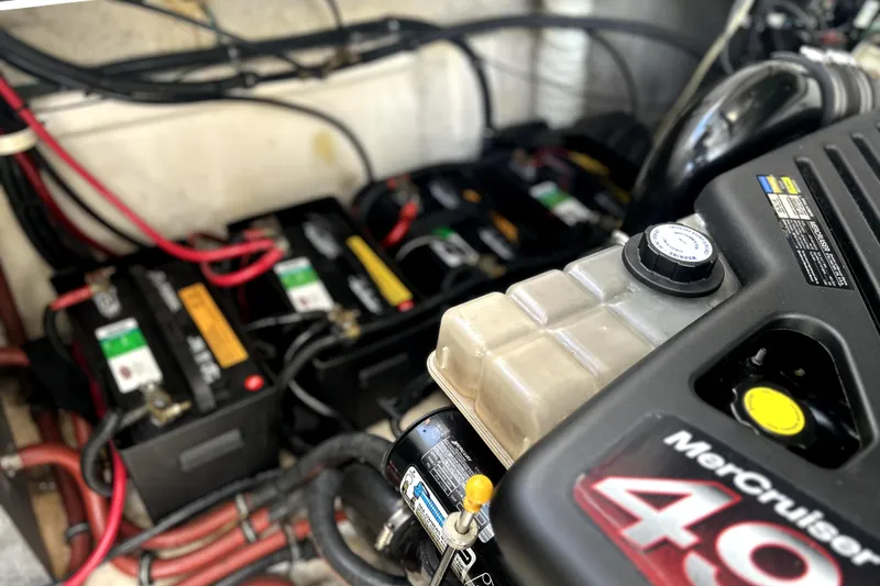 Slide: The Image of Engine compartment of 2004 Wellcraft 47 Excalibur with MerCruiser components and batteries. - 52