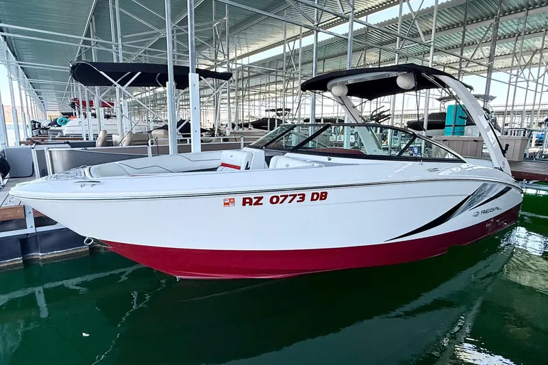 The Image of 2020 Regal LS4 Surf boat docked in marina, white and red design. - 0