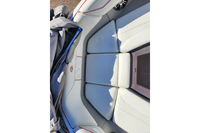 Slide: The Image of 2020 Regal LS4 Surf boat interior with white cushioned seating and speaker. - 14