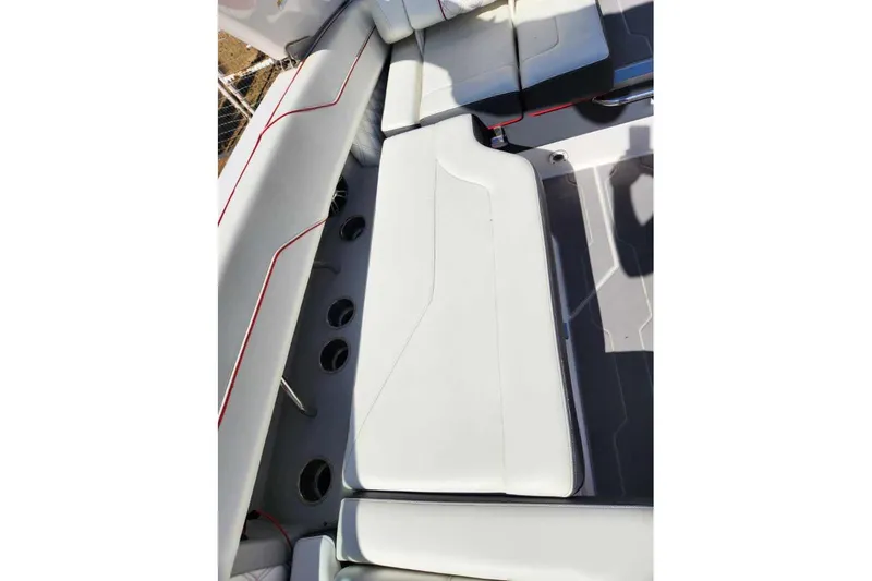 Slide: The Image of 2020 Regal LS4 Surf boat interior with white seating and cup holders. - 17