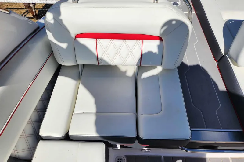 Slide: The Image of 2020 Regal LS4 Surf boat interior with white and red cushioned seating. - 19