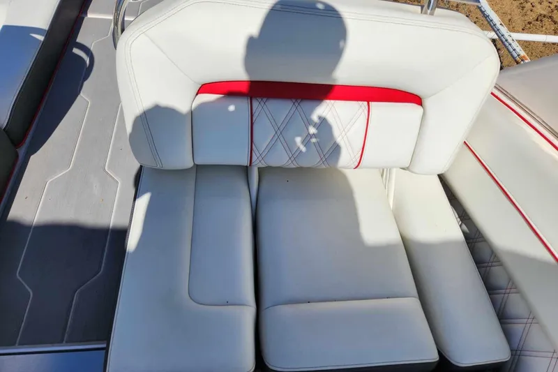 Slide: The Image of 2020 Regal LS4 Surf boat interior with white and red cushioned seating. - 20