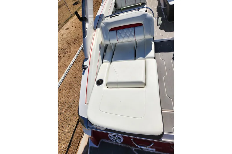 Slide: The Image of 2020 Regal LS4 Surf boat with white cushioned seating and red accents. - 22
