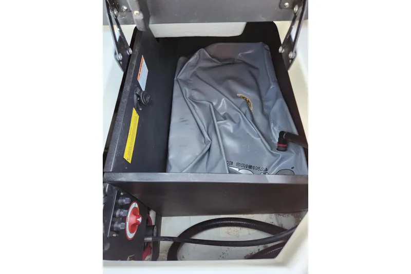 Slide: The Image of 2020 Regal LS4 Surf boat ballast compartment with gray bag and control panel. - 23