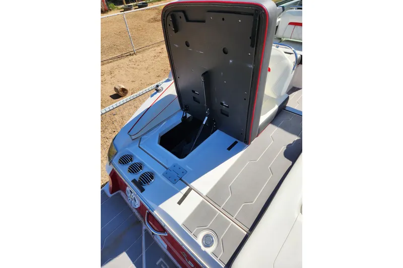 Slide: The Image of 2020 Regal LS4 Surf boat interior with open storage compartment, showcasing sleek design. - 26