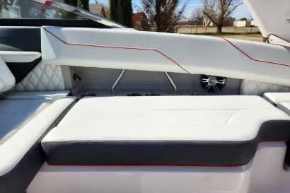 Slide: The Image of 2020 Regal LS4 Surf boat interior with white and gray seating, red accents. - 27