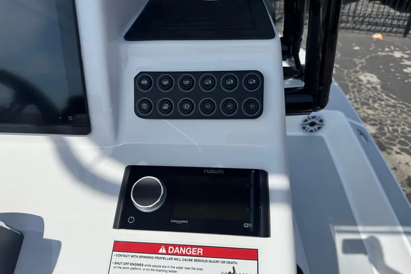 Slide: The Image of Control panel of 2026 SCB R24 boat with buttons and warning label. - 14