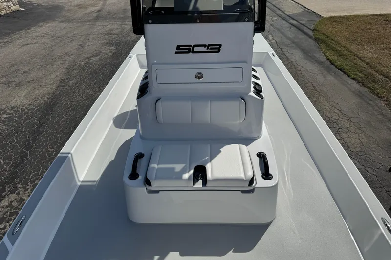 Slide: The Image of 2026 SCB R24 boat console with seating and storage on a paved surface. - 19