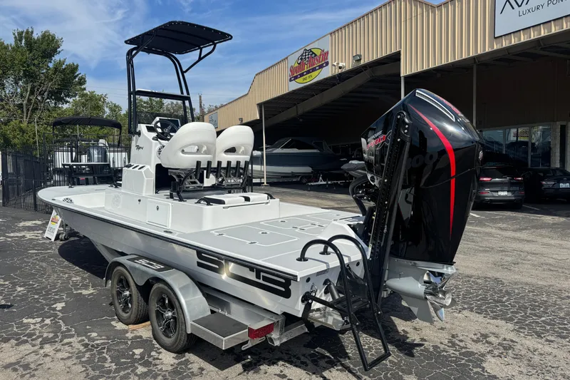 Slide: The Image of 2026 SCB R24 boat with dual seats and powerful outboard motor on a trailer. - 2