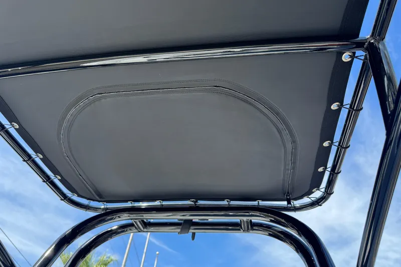 Slide: The Image of 2026 SCB R24 boat canopy with sleek black frame under blue sky. - 31