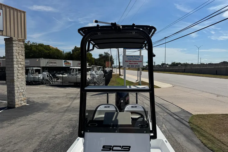 Slide: The Image of 2026 SCB R24 boat parked outside dealership on a sunny day. - 32