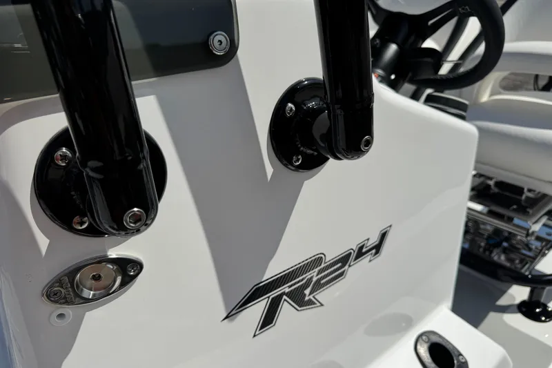 Slide: The Image of 2026 SCB R24 boat dashboard with steering wheel and rod holders. - 33