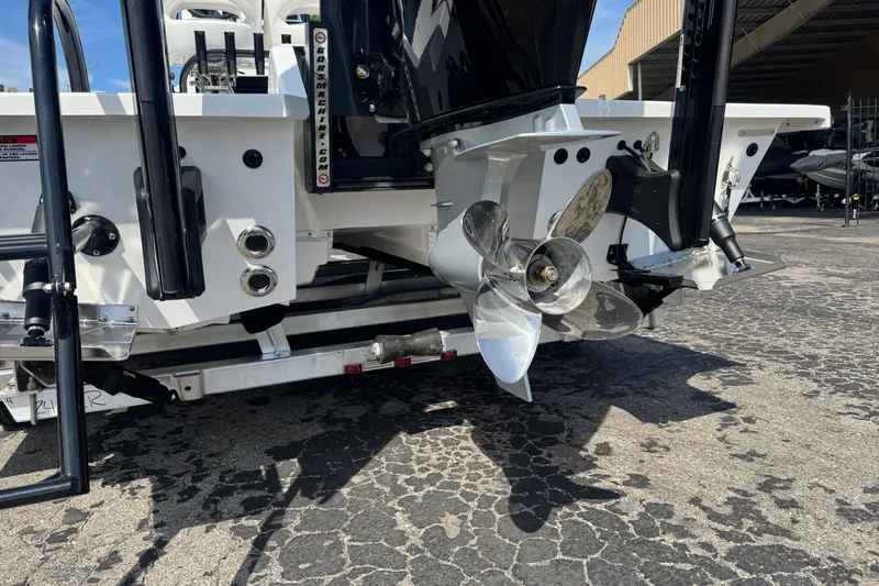 Slide: The Image of 2026 SCB R24 boat with stainless steel propeller and dual exhaust, parked on textured pavement. - 4