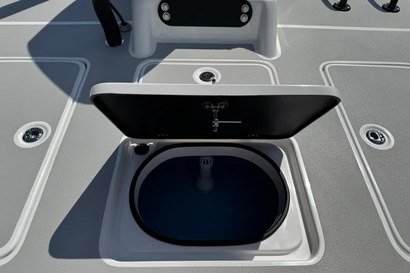 Slide: The Image of Open hatch on 2026 SCB R24 boat deck, revealing storage compartment. - 40
