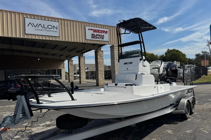 Slide: The Image of 2026 SCB R24 boat on trailer outside Avalon Luxury Pontoons dealership. - 5