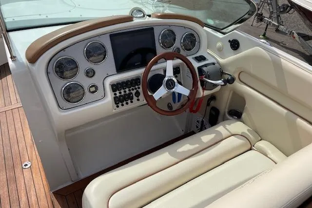 Slide: The Image of 2008 Chris-Craft Launch 28 boat interior with steering wheel and dashboard controls. - 13