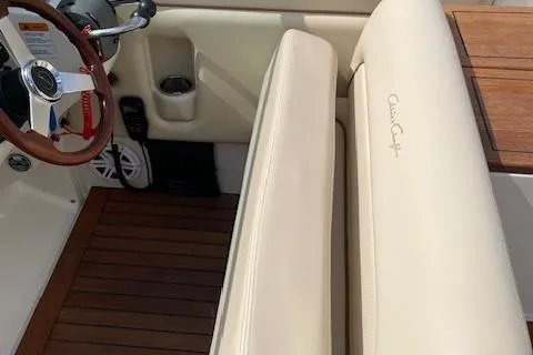 Slide: The Image of 2008 Chris-Craft Launch 28 interior with beige seating and wooden flooring. - 14