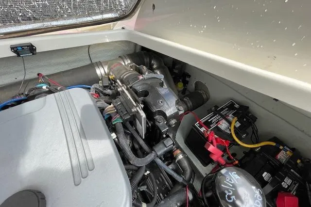 Slide: The Image of Engine compartment of 2008 Chris-Craft Launch 28 boat, showing mechanical components and battery. - 19