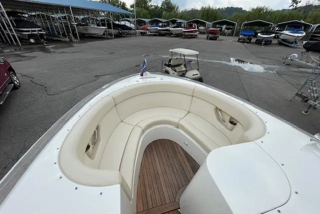 Slide: The Image of 2008 Chris-Craft Launch 28 boat with white seating and wooden deck in a marina. - 21