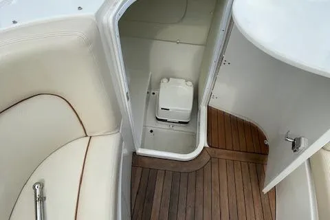 Slide: The Image of 2008 Chris-Craft Launch 28 boat interior with wooden flooring and compact toilet. - 22