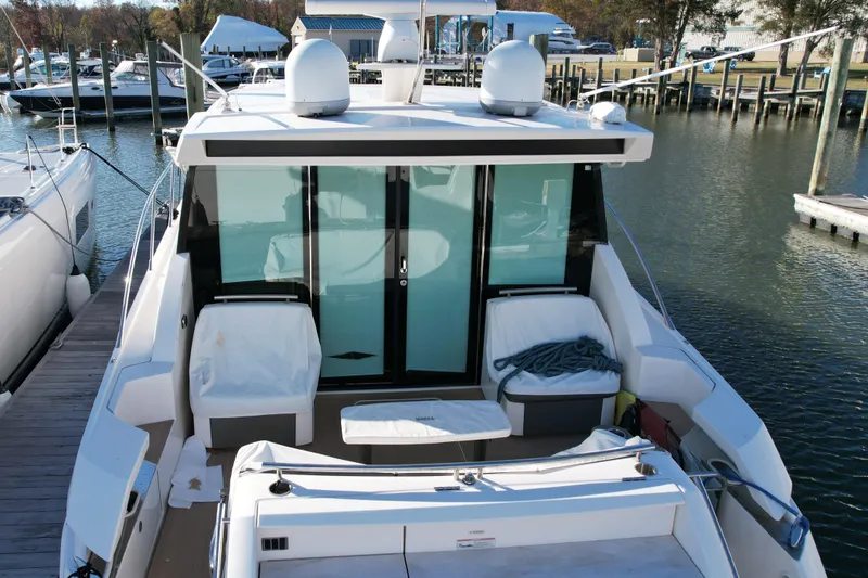 Slide: The Image of 2017 Tiara 44 Coupe boat on stands, showcasing sleek design and blue hull. - 15