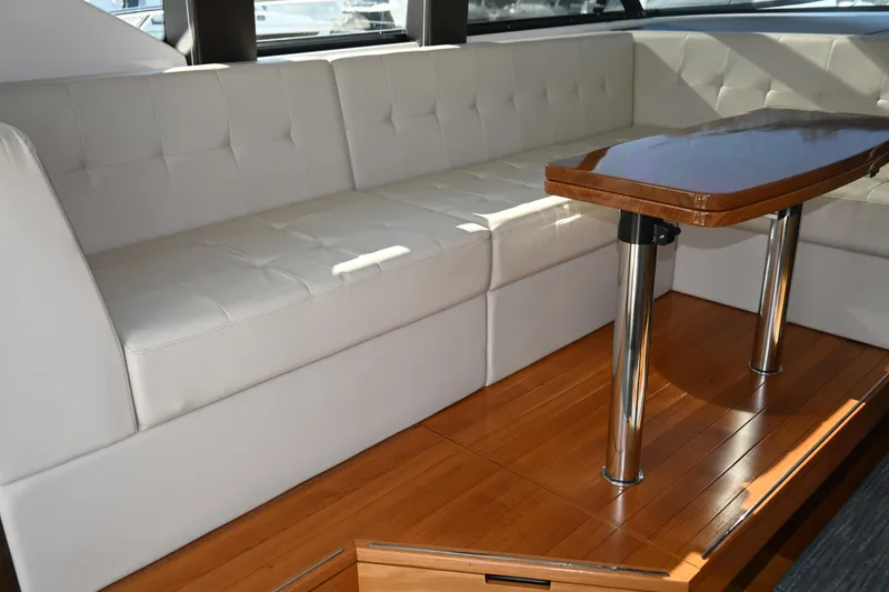 Slide: The Image of Luxurious white leather electrically adjustable helm seat in 2017 Tiara 44 Coupe yacht interior. - 30