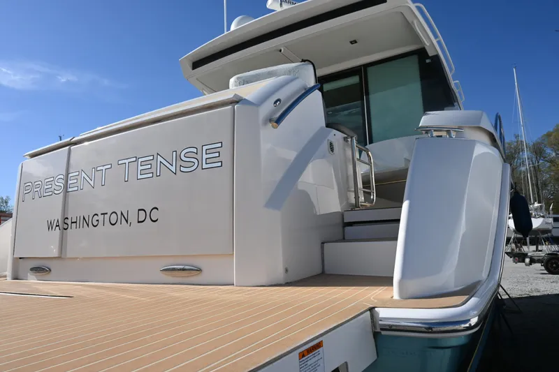 Slide: The Image of Luxurious interior of 2017 Tiara 44 Coupe with white seating and wooden table. - 7