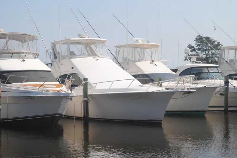 The Image of 1999 Ocean Yachts 45 Super Sport docked among other boats in a marina. - 0