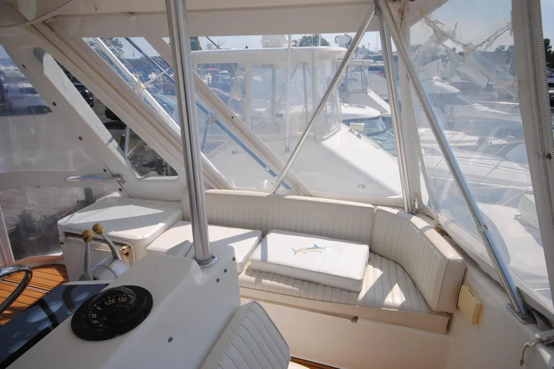 Slide: The Image of 1999 Ocean Yachts 45 Super Sport interior with seating and helm, featuring clear windows. - 10