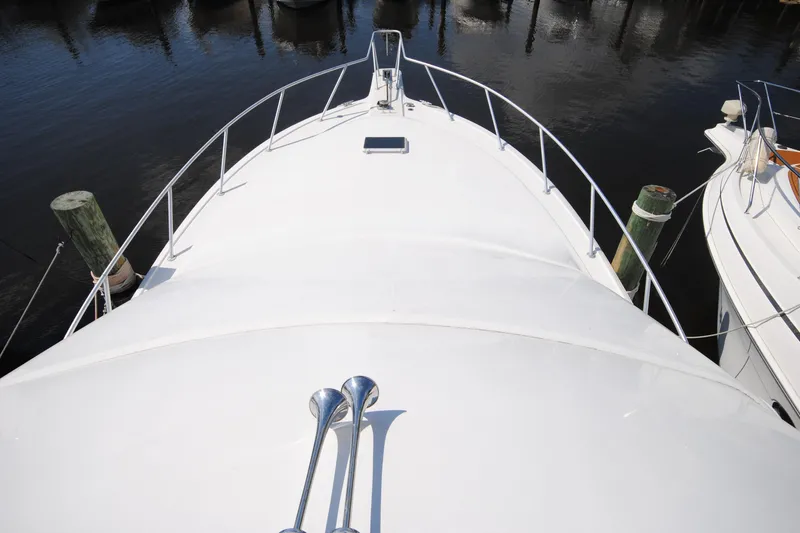 Slide: The Image of Bow view of 1999 Ocean Yachts 45 Super Sport docked at marina. - 11