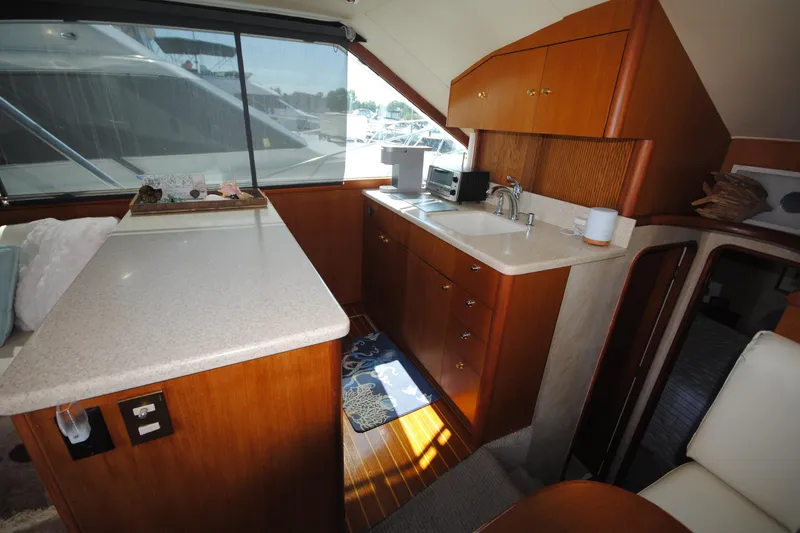 Slide: The Image of Interior of 1999 Ocean Yachts 45 Super Sport with kitchenette and seating area. - 19