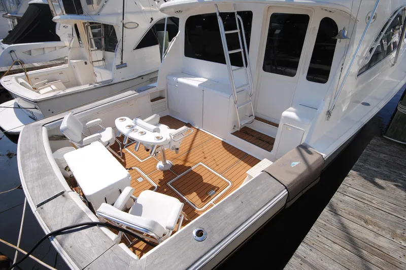 Slide: The Image of 1999 Ocean Yachts 45 Super Sport with spacious deck and seating area at the marina. - 2