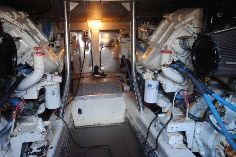 Slide: The Image of Engine room of 1999 Ocean Yachts 45 Super Sport, showcasing dual engines and mechanical components. - 32