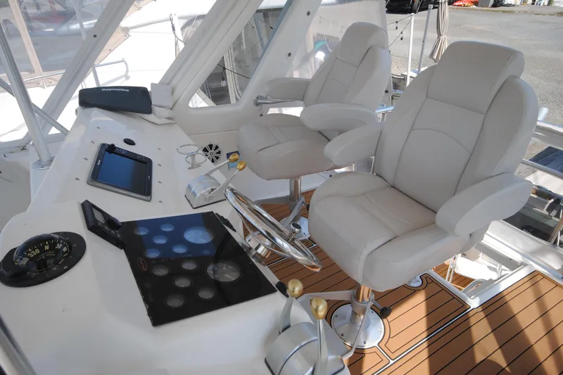 Slide: The Image of 1999 Ocean Yachts 45 Super Sport helm with dual captain chairs and navigation equipment. - 7