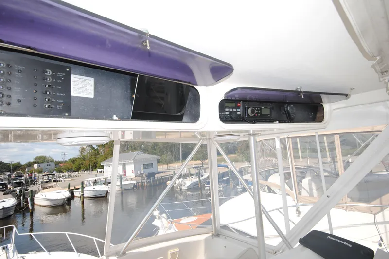 Slide: The Image of 1999 Ocean Yachts 45 Super Sport cockpit with control panels and marina view. - 8