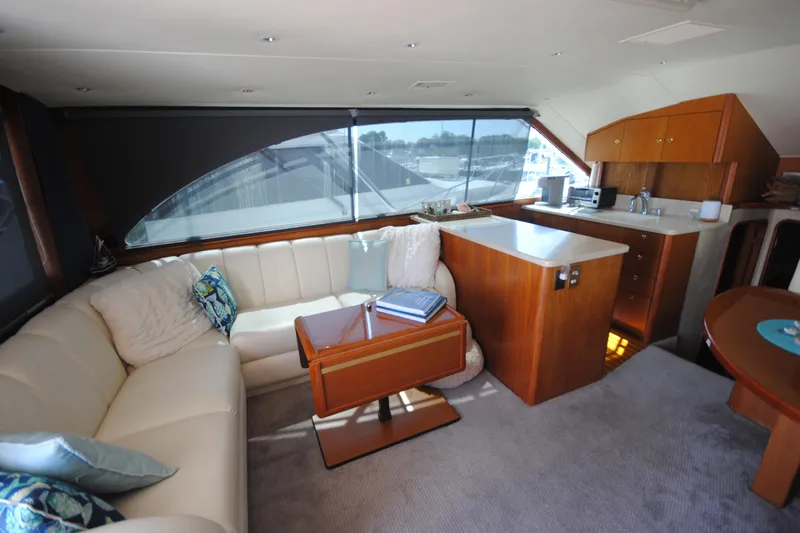 Slide: The Image of Luxurious interior of a 1999 Ocean Yachts 45 Super Sport with elegant seating and kitchenette. - 15