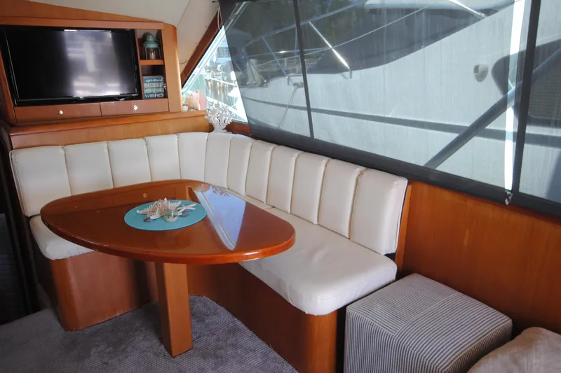 Slide: The Image of Interior of 1999 Ocean Yachts 45 Super Sport with dining area and TV. - 18