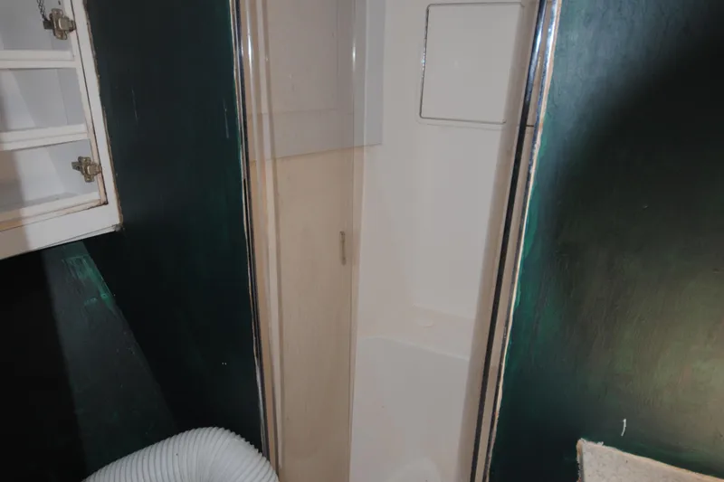 Slide: The Image of Shower area in 1999 Ocean Yachts 45 Super Sport boat bathroom. - 25