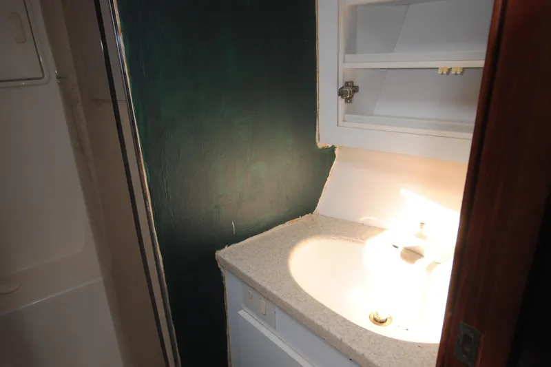 Slide: The Image of Bathroom sink area in a 1999 Ocean Yachts 45 Super Sport boat. - 26
