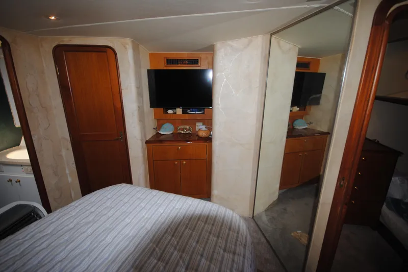 Slide: The Image of Interior of 1999 Ocean Yachts 45 Super Sport with TV and wooden cabinetry. - 29