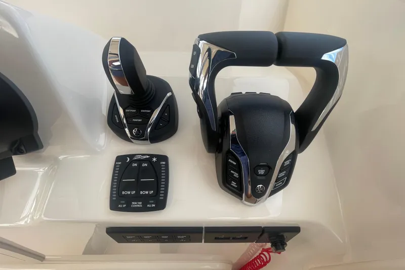 Slide: The Image of Control panel of 2026 Grady-White Freedom 307 boat with joystick and throttle. - 11