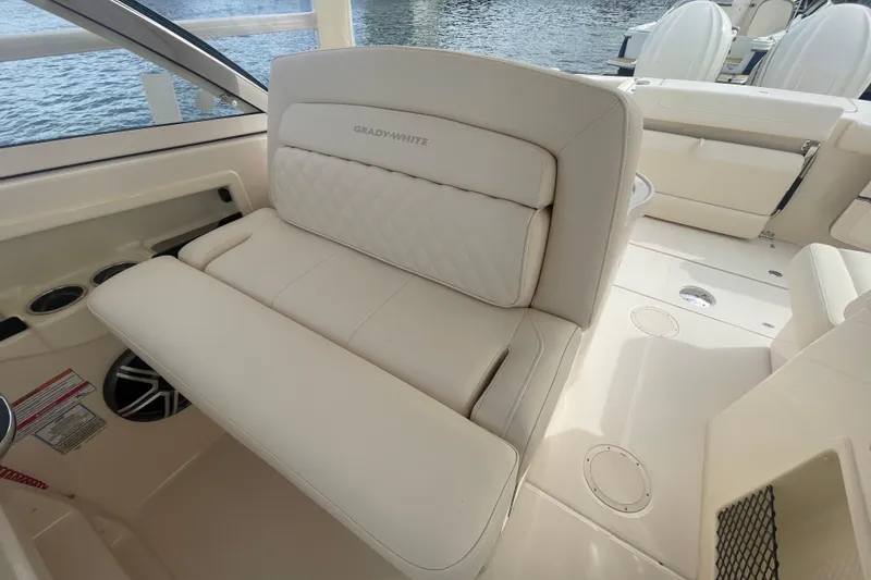 Slide: The Image of 2026 Grady-White Freedom 307 boat interior with luxurious seating and cup holders. - 13