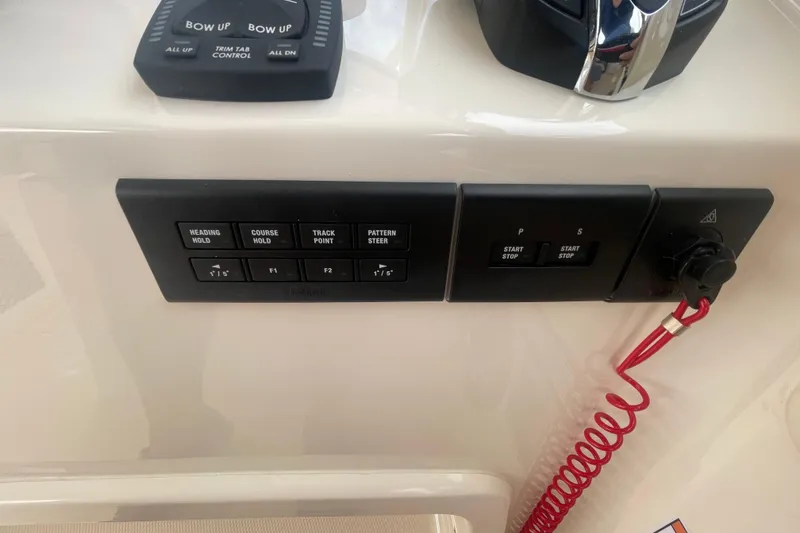 Slide: The Image of Control panel of 2026 Grady-White Freedom 307 boat with various navigation buttons. - 16