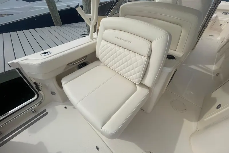 Slide: The Image of Luxurious seating on 2026 Grady-White Freedom 307 boat, featuring elegant white upholstery. - 18