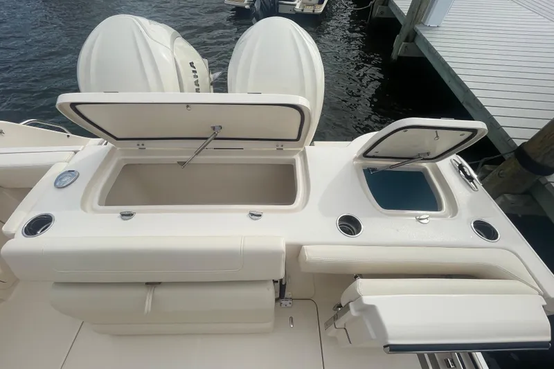 Slide: The Image of 2026 Grady-White Freedom 307 boat with open storage compartments at the dock. - 20
