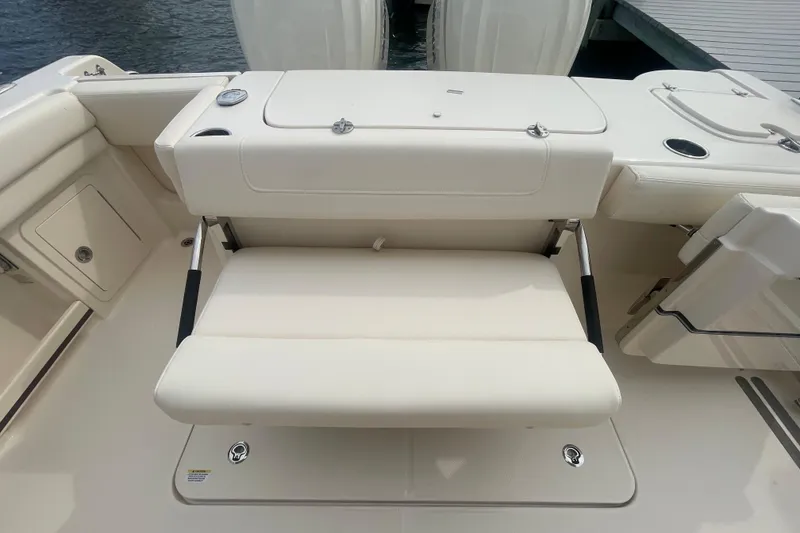 Slide: The Image of 2026 Grady-White Freedom 307 boat interior with foldable seating and storage compartments. - 23