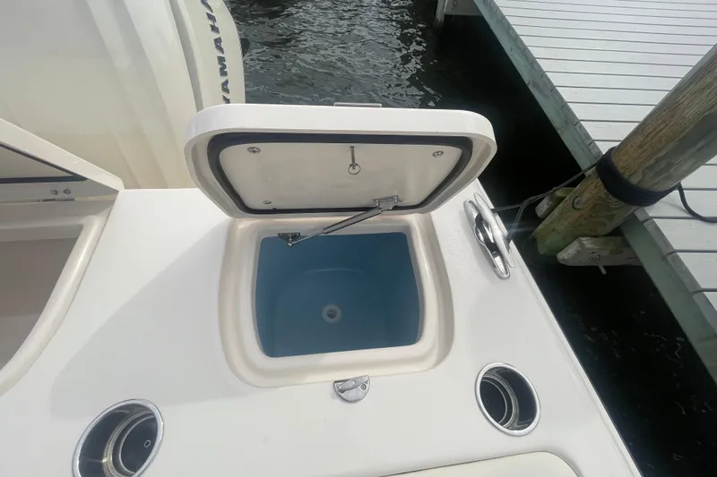 Slide: The Image of Open storage compartment on 2026 Grady-White Freedom 307 boat, dockside view. - 24